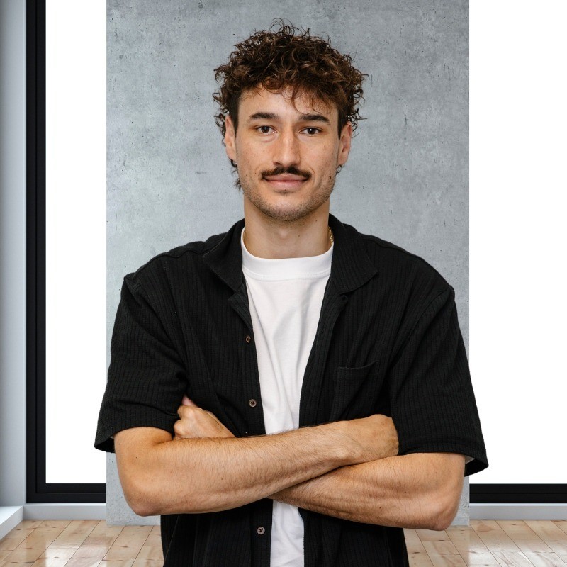 Tom Kubank standing with arms folded